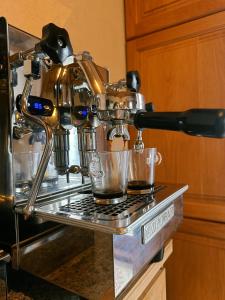 a coffee machine with two cups on a counter at Romantisches Wellness Chalet im steirischen Ursprung 