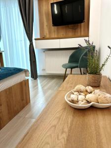 a table with a plate of food on top of it at Apartamente Victory Luxury Eforie Nord in Eforie Nord