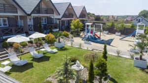 a backyard with a playground with chairs and a slide at Sunny Baltic in Jarosławiec