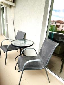 drie stoelen en een tafel op een balkon bij Victory Luxury Apartments in Eforie Nord