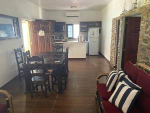cocina y sala de estar con mesa y sillas en Casa Elohim, en Iztapa