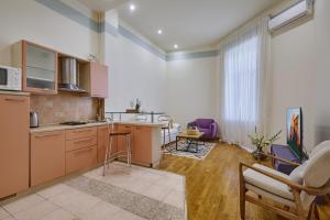 a kitchen with a table and chairs in a room at Apartments near the Golden Gate in Kyiv