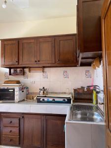 a kitchen with wooden cabinets and a stove top oven at Dar Saada Imm. 5 in Marrakesh