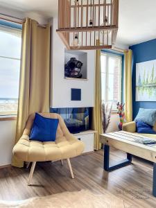 a living room with a couch and a chair at AS 50 - Les bateaux au bord de l'eau in Ault +38 photos