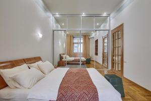 a bedroom with a large bed with glass walls at Apartments near the Golden Gate in Kyiv