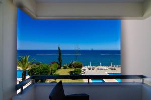 a room with a view of the ocean from a balcony at Gulf Palace Apartments in Limassol