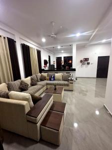 a living room with two couches and a table at DreamScape Holiday Apartment in Kalutara