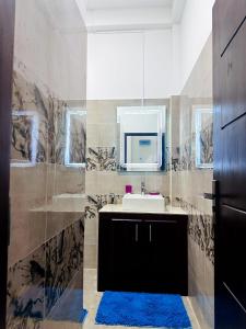 a bathroom with a sink and a mirror at DreamScape Holiday Apartment in Kalutara