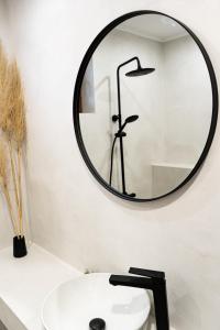 a bathroom with a mirror above a white sink at Dion Apartments in Lozenets