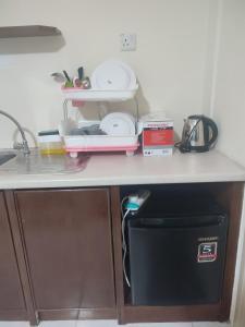 a kitchen counter with a sink and a dishwasher at Sofea Inn Bukit Merah - Laketown A6153 in Kampong Selemat