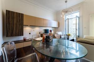 - une cuisine avec une table en verre dans une pièce dans l'établissement LIGHTHOUSE KEYWEEK Apartment Biarritz, à Biarritz