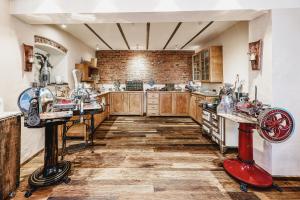 a kitchen with wooden cabinets and a brick wall at Hotel Zeltinger-Hof - Gasthaus des Rieslings in Zeltingen-Rachtig