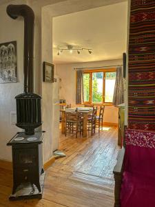 a living room with a stove and a dining room at Camping Kromidovo in Kromidovo