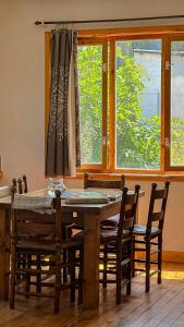 a dining room table with chairs and a window at Camping Kromidovo in Kromidovo