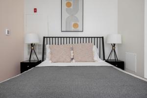 a bedroom with a large bed with two lamps at South Boston studio w wd nr red line BOS-888 in Boston