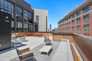 a patio with chairs and tables on a building at South Boston studio w wd nr red line BOS-888 in Boston