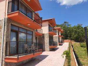 a row of houses with balconies on a street at La Vie En Rose Hotel by Sogutdagi Isparta in Keçiborlu