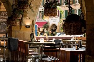 an empty restaurant with tables and chairs and plants at ADLER Boutique Hotel in Murten