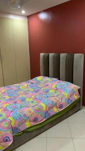 a bed with a colorful blanket on top of it at TRIO in Agadir