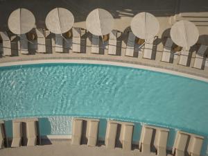 an overhead view of a swimming pool with chairs and tables at Yi Hotel Mykonos in Elia Beach