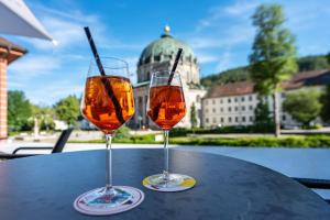 two wine glasses sitting on top of a table at Kloster Meister Haus Apartment 11 in St. Blasien