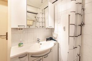 a white bathroom with a sink and a mirror at Kloster Meister Haus Apartment 11 in St. Blasien
