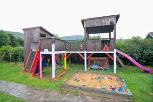 a play area with a playground with a play house at Bouda Berounka 