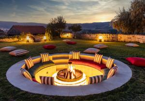 a fire pit in the middle of a grass field at Utopia Cave Cappadocia in Urgup