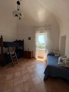 a bedroom with a bed and a window in a room at Farm seaview on Capri in Termini