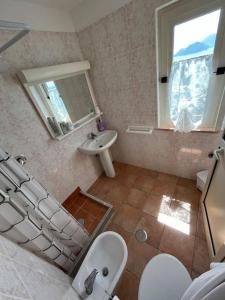a bathroom with a sink and a toilet and a mirror at Farm seaview on Capri in Termini