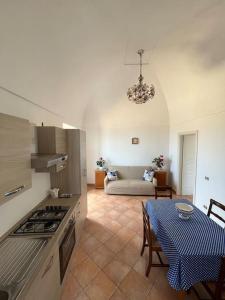a kitchen and living room with a table and a stove at Farm seaview on Capri in Termini
