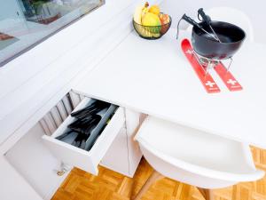 a white kitchen counter with a drawer at Cozy modern Studio super location feels like home in Crans-Montana