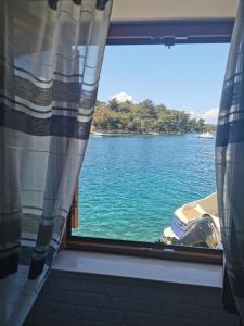 a window with a view of a body of water at Apartments Melany in Slano
