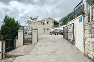 a driveway with a gate and a car parked in a parking lot at Urban escape for two in Kotor in Kotor