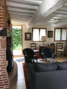 a living room with a couch and a fireplace at Le Gîte du Vivier in Valmont
