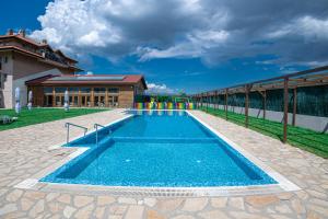 a swimming pool in front of a building at Thermal Hotel Seven Seasons in Banya