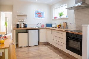 a kitchen with a sink and a stove at No.51 in Lymington