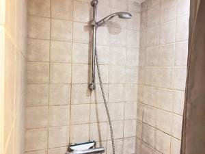 a shower with a shower head in a bathroom at Four Bedroom Apartment In Esbjerg, Kirkegade 12 in Esbjerg +28 photos