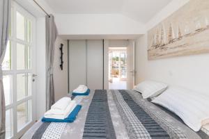 a bedroom with two beds and a window at Apartment ACI Marina MILNA Brač in Milna +36 photos