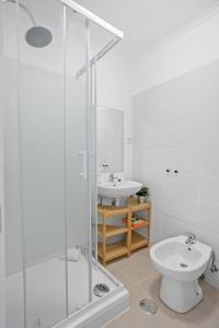 a bathroom with a shower and a toilet and a sink at One bedroom Apt in Almada with River view! in Almada