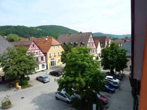 a view of a town with cars parked in a parking lot at Stadtapartments am Marktplatz in Ebermannstadt