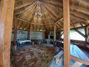 an inside view of a large room with a wooden ceiling at Domki Ranczo na Załpie in Laskowa