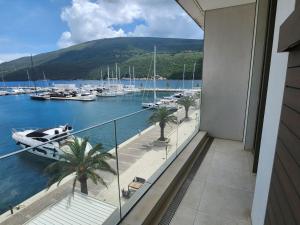 a balcony with a view of a marina with boats at Portonovi - Marina Residences Sea View Apartment in Herceg-Novi