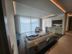 a living room with a couch and a table at Portonovi - Marina Residences Sea View Apartment in Herceg-Novi
