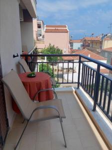 a table and chairs on the balcony of a apartment at Papas Studios in Skala Marion +46 photos