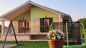 a house with a porch and a plant in front of it at Kuća za odmor Neli in Sukošan