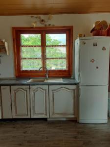 a kitchen with a sink and a white refrigerator at Kuća za odmor Neli in Sukošan