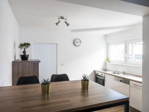a kitchen with a wooden table with two plants on it at Wohnung Forst in Forst