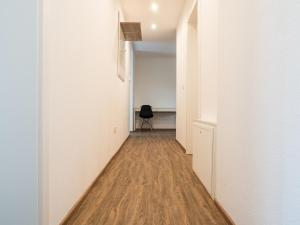a hallway with white walls and a wooden floor at Wohnung Forst in Forst