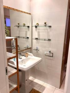 a white bathroom with a sink and a mirror at Private Pool Luxury Penthouse in Eilat